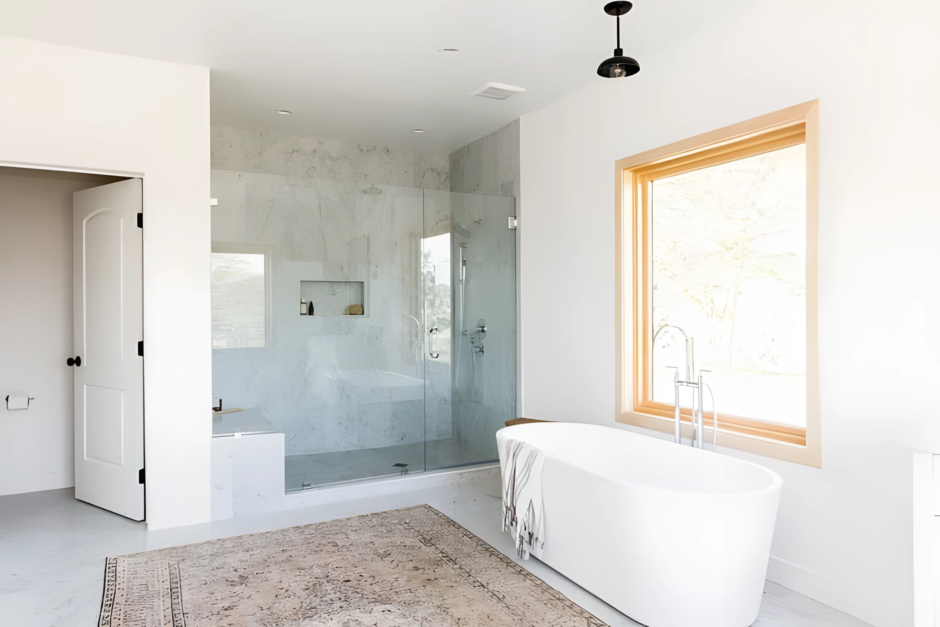 Modern bathroom featuring a freestanding bathtub and shower enclosure