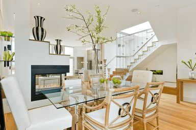 Modern dining area featuring a glass table and stylish decor.
