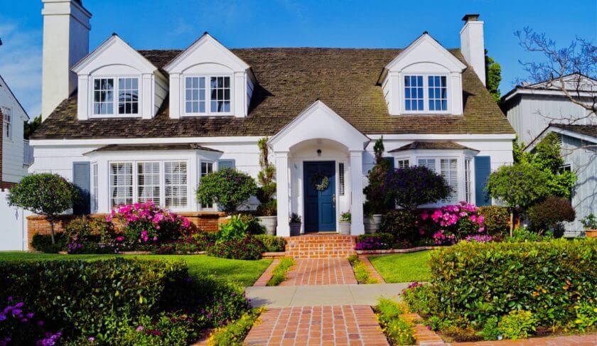 Charming house with landscaping and flowers